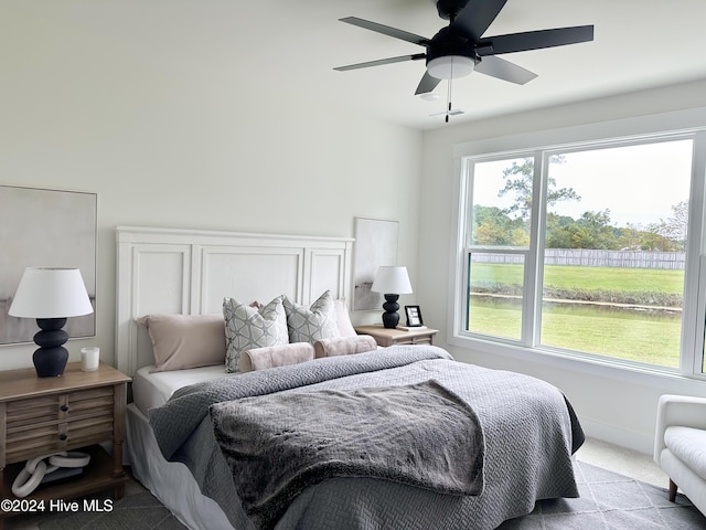 carpeted bedroom with baseboards and ceiling fan