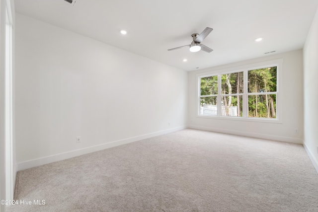 carpeted empty room with visible vents, recessed lighting, baseboards, and ceiling fan