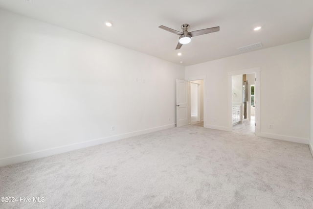 empty room with baseboards, recessed lighting, visible vents, and light carpet