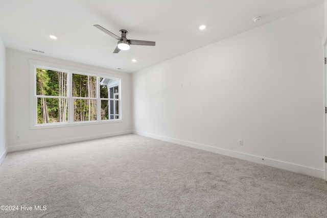 carpeted empty room with visible vents, recessed lighting, baseboards, and ceiling fan