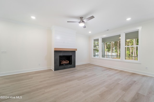 unfurnished living room with ceiling fan, baseboards, ornamental molding, and light wood finished floors