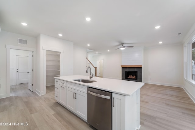 kitchen featuring white cabinetry, dishwasher, sink, a kitchen island with sink, and light hardwood / wood-style flooring