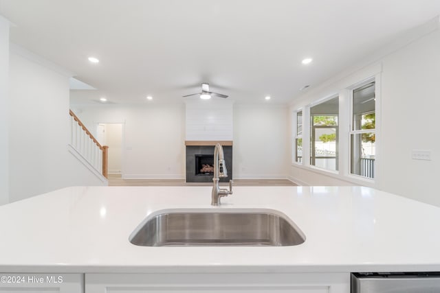 kitchen with ceiling fan, a sink, light countertops, dishwasher, and open floor plan