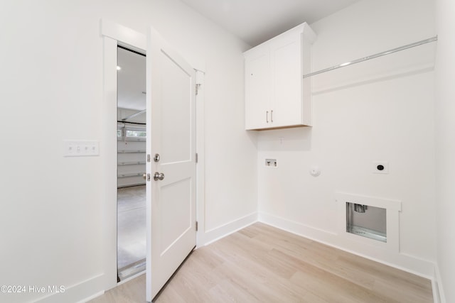 washroom featuring baseboards, hookup for a washing machine, light wood-style floors, cabinet space, and hookup for an electric dryer