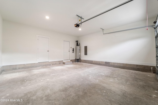 garage with electric panel, a garage door opener, and electric water heater