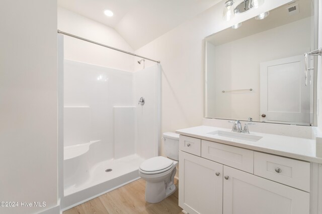 bathroom with vanity, hardwood / wood-style floors, toilet, and walk in shower