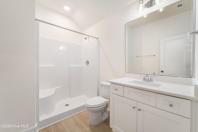 bathroom with vanity, wood finished floors, visible vents, walk in shower, and toilet