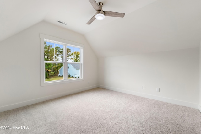 additional living space featuring visible vents, baseboards, carpet, lofted ceiling, and ceiling fan