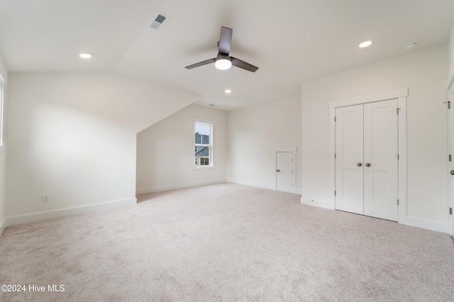 bonus room featuring ceiling fan, light colored carpet, and lofted ceiling