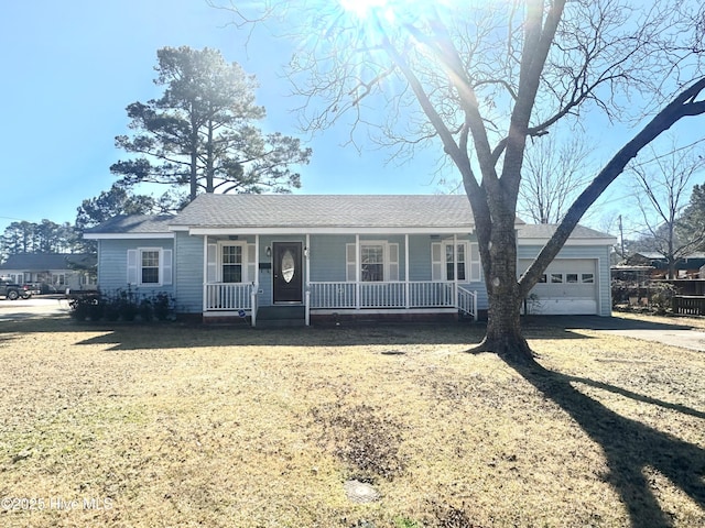 single story home with a porch, a front lawn, and a garage