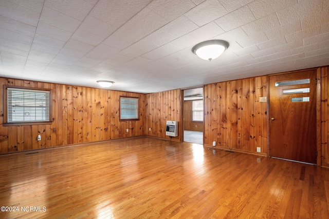 interior space with wood-type flooring and heating unit