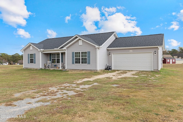 ranch-style home with a garage and a front lawn