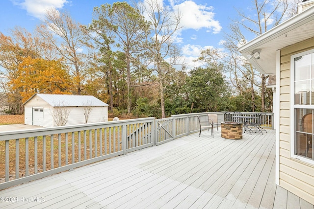 wooden deck featuring an outdoor fire pit