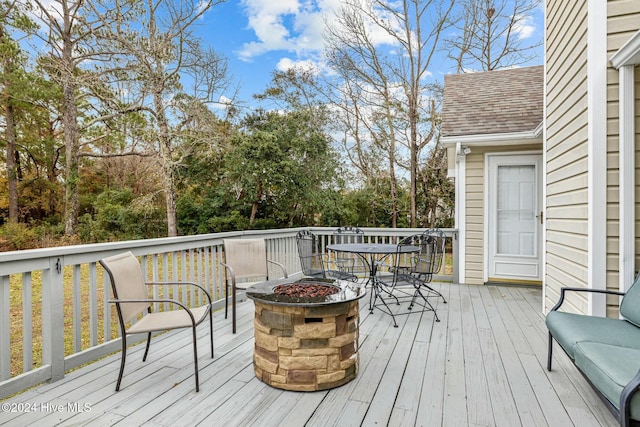 wooden terrace with a fire pit