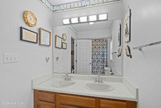 bathroom with vanity, toilet, and walk in shower