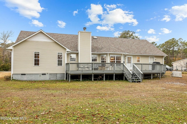 back of property featuring a yard and a deck