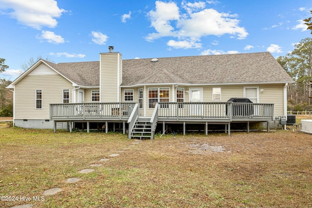 rear view of house featuring a yard, a deck, and central air condition unit