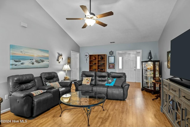 living room featuring ceiling fan, light wood-type flooring, and lofted ceiling