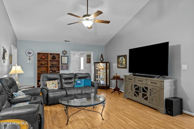 living room with ceiling fan, lofted ceiling, and light hardwood / wood-style flooring