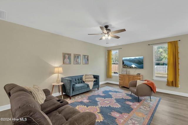 living room featuring hardwood / wood-style flooring and ceiling fan