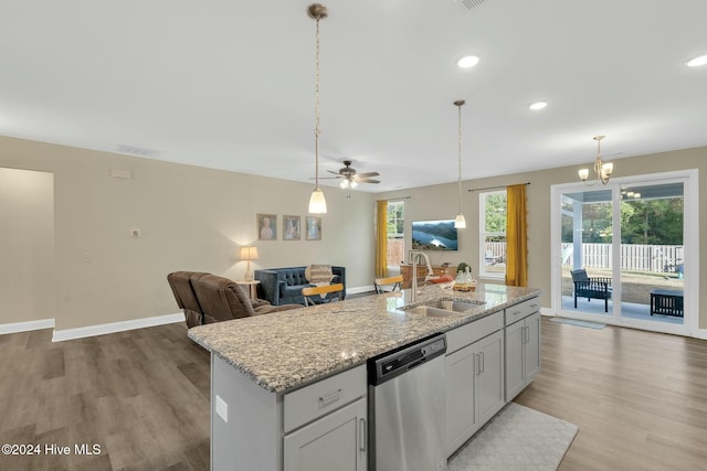 kitchen with dishwasher, light hardwood / wood-style flooring, a kitchen island with sink, and sink