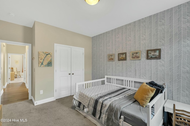 carpeted bedroom with a closet