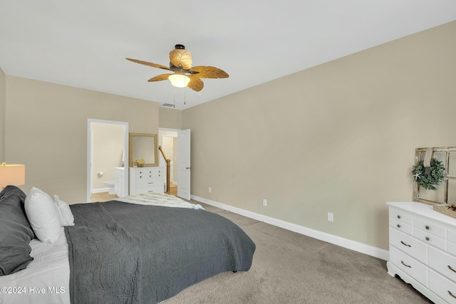 carpeted bedroom featuring ceiling fan and ensuite bath