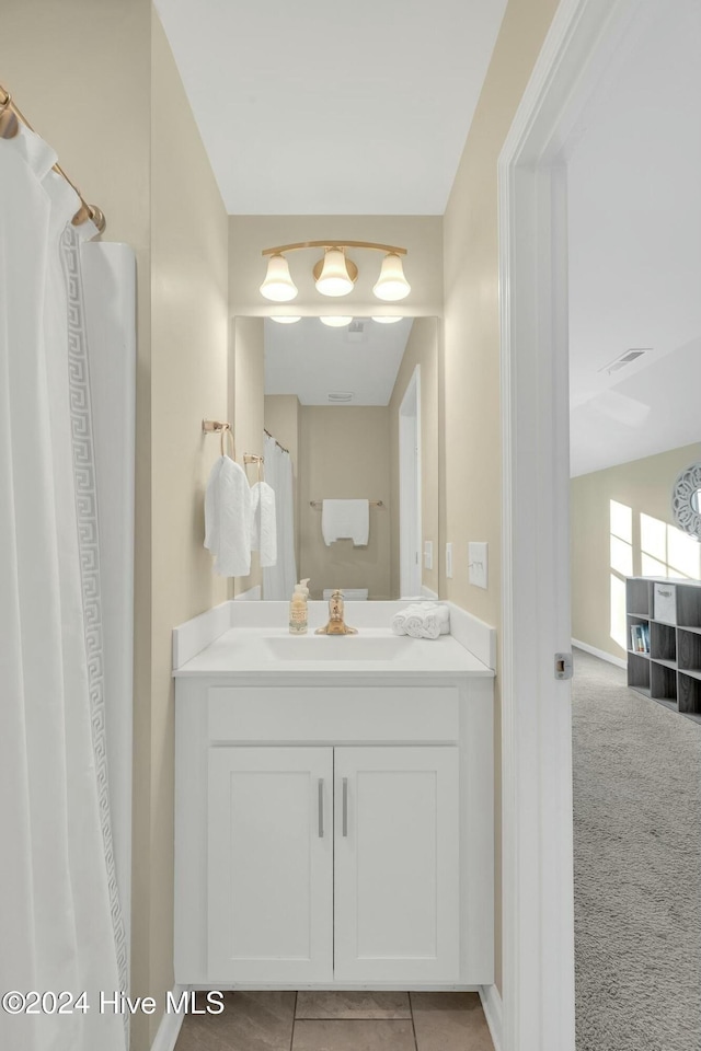 bathroom with tile patterned flooring and vanity