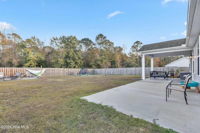 view of yard featuring a patio, a trampoline, and an outdoor hangout area