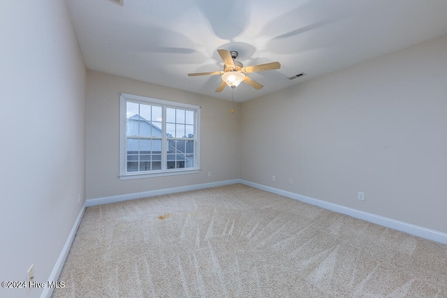 spare room with light colored carpet and ceiling fan