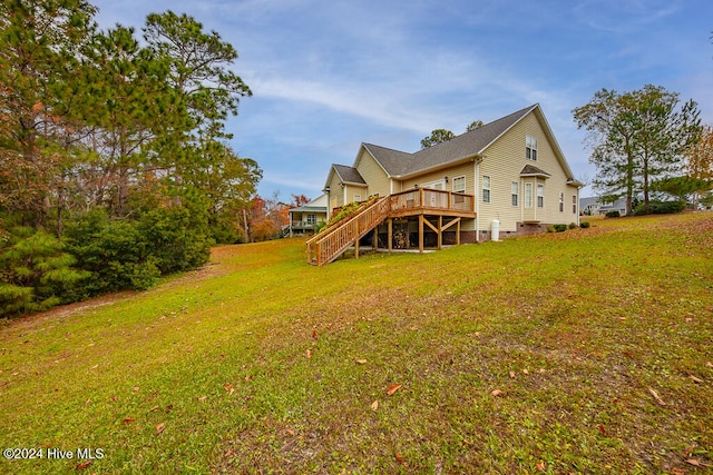 back of house featuring a lawn and a wooden deck