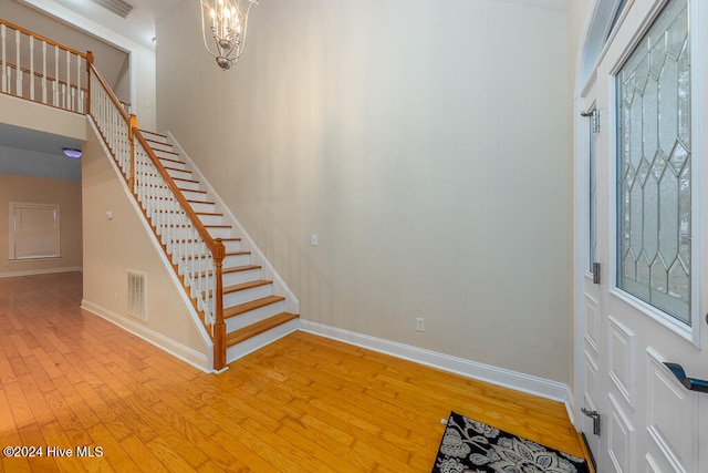 entryway featuring light hardwood / wood-style floors, an inviting chandelier, and a wealth of natural light