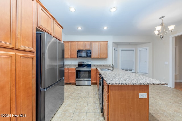 kitchen with sink, light stone counters, a chandelier, decorative light fixtures, and black appliances