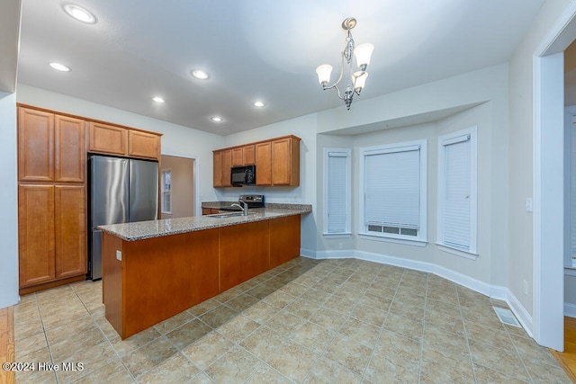 kitchen with kitchen peninsula, sink, decorative light fixtures, an inviting chandelier, and stainless steel refrigerator