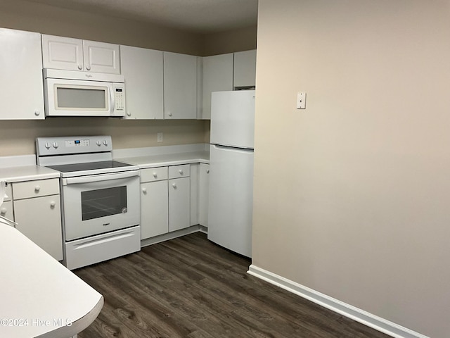 kitchen with white cabinets, white appliances, and dark hardwood / wood-style floors