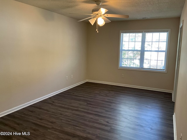 unfurnished room featuring a textured ceiling, ceiling fan, and dark wood-type flooring