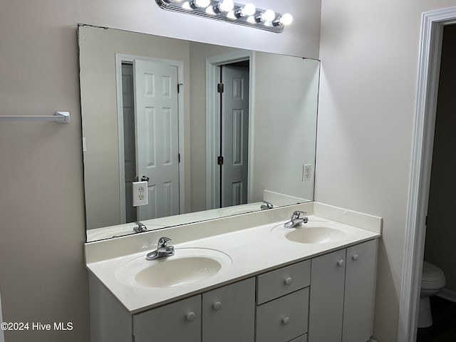 bathroom featuring vanity and toilet