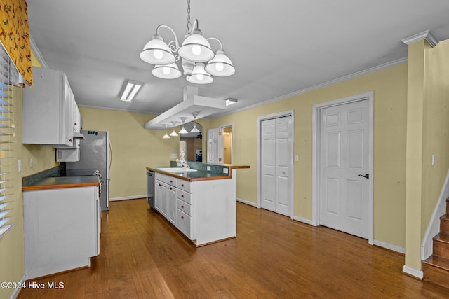 kitchen featuring hardwood / wood-style floors, an inviting chandelier, white cabinets, hanging light fixtures, and ornamental molding