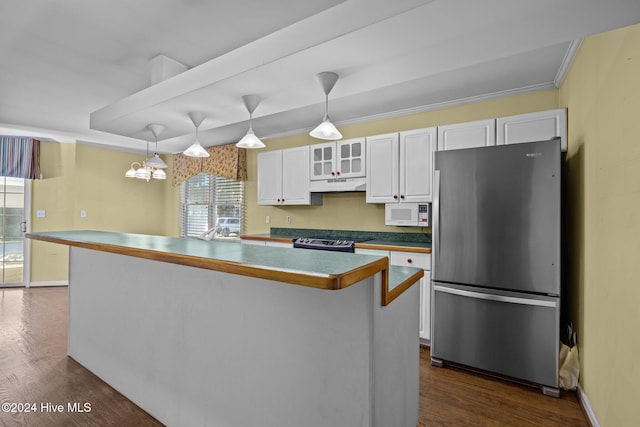 kitchen featuring white cabinetry, dark hardwood / wood-style flooring, pendant lighting, and appliances with stainless steel finishes