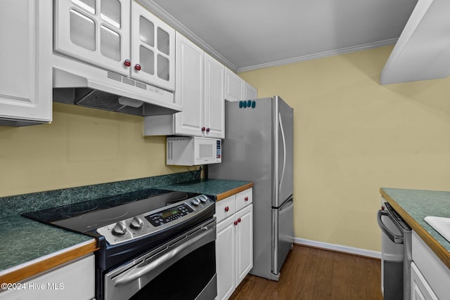 kitchen with white cabinets, dark hardwood / wood-style flooring, ornamental molding, and appliances with stainless steel finishes