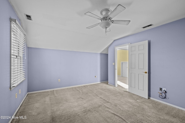 additional living space with light carpet, vaulted ceiling, and ceiling fan