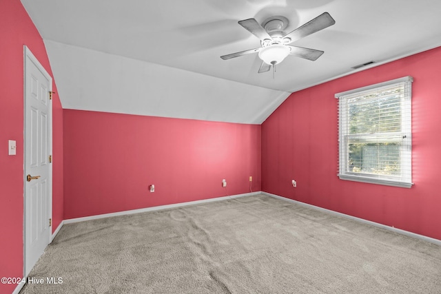 additional living space featuring carpet flooring, vaulted ceiling, and ceiling fan