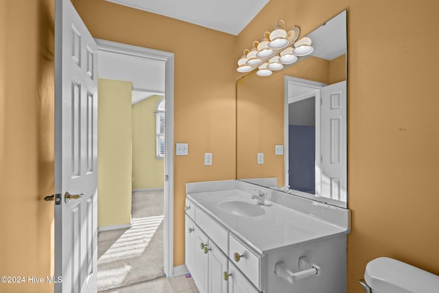 bathroom featuring tile patterned flooring, vanity, and toilet