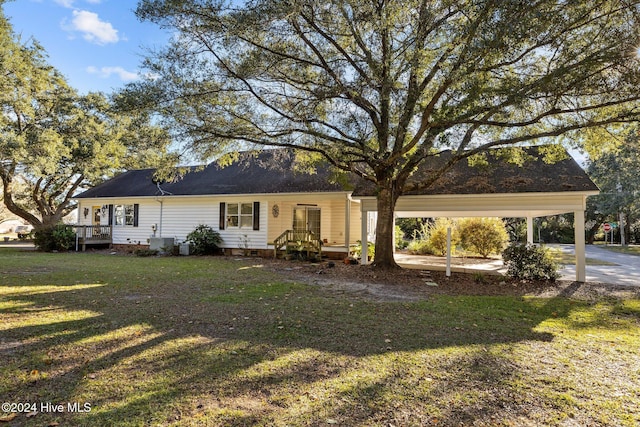 view of front facade with a carport and a front lawn