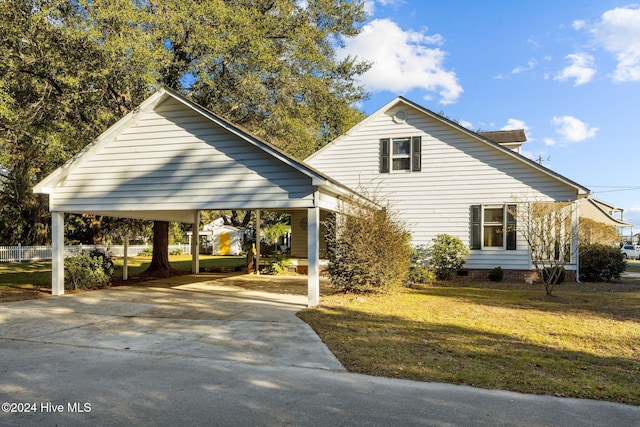 view of front of house with a front yard and a carport