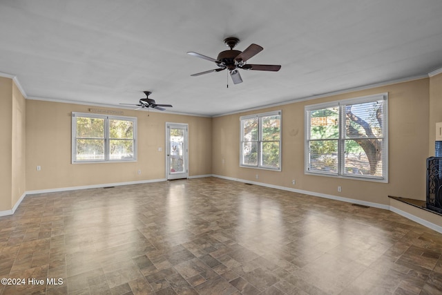 unfurnished living room featuring ornamental molding, ceiling fan, and a healthy amount of sunlight