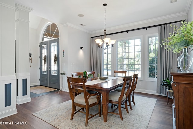 dining room featuring french doors, dark hardwood / wood-style flooring, an inviting chandelier, and ornamental molding