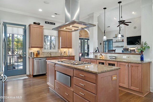 kitchen with kitchen peninsula, stainless steel appliances, island range hood, pendant lighting, and dark hardwood / wood-style floors