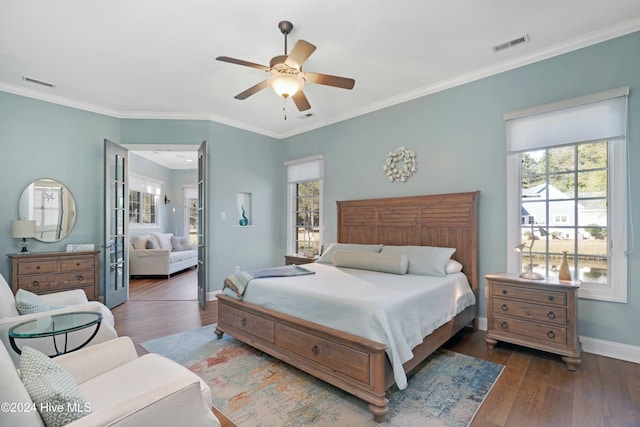 bedroom featuring multiple windows, ceiling fan, crown molding, and dark wood-type flooring