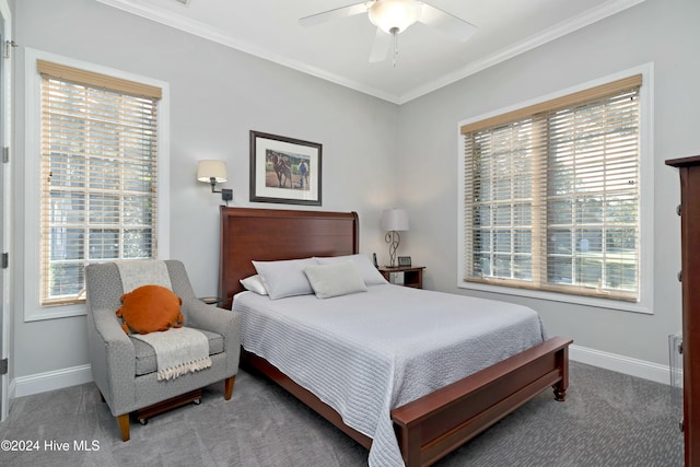 bedroom with ceiling fan, crown molding, and carpet floors